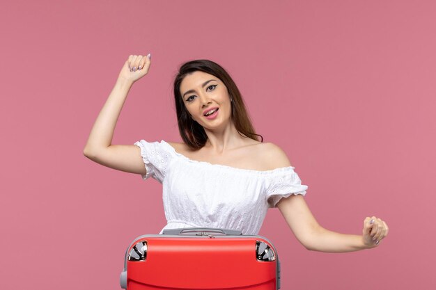 Front view young female preparing for vacation and feeling excited on pink background abroad sea journey travel trip voyage