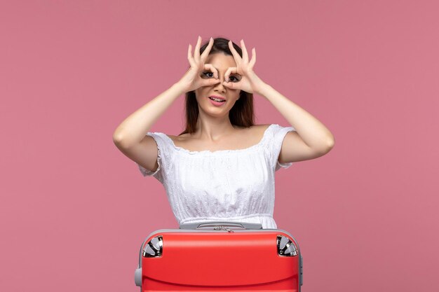 Front view young female preparing for vacation on pink background abroad trip sea journey travel voyage