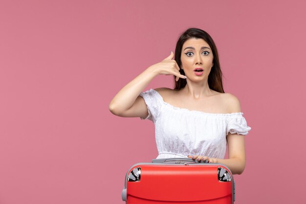 Front view young female preparing for vacation on the pink background vacation abroad travel trip voyage