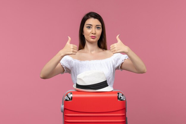 Front view young female preparing for vacation and posing on pink background journey travelling trip abroad sea voyage