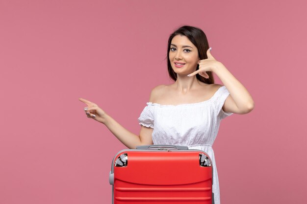 Front view young female preparing for vacation and smiling on pink background journey abroad travel sea voyage trip