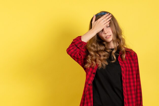 Front view young female in red checkered shirt posing and feeling stressed on yellow background model girls woman emotion human female color