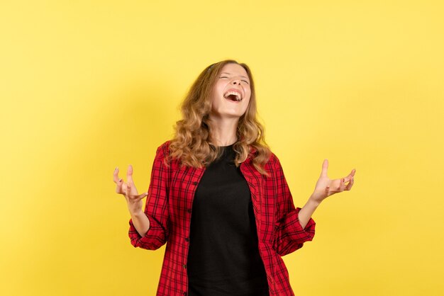 Front view young female in red checkered shirt posing with emotions on yellow background human girl emotion color model woman