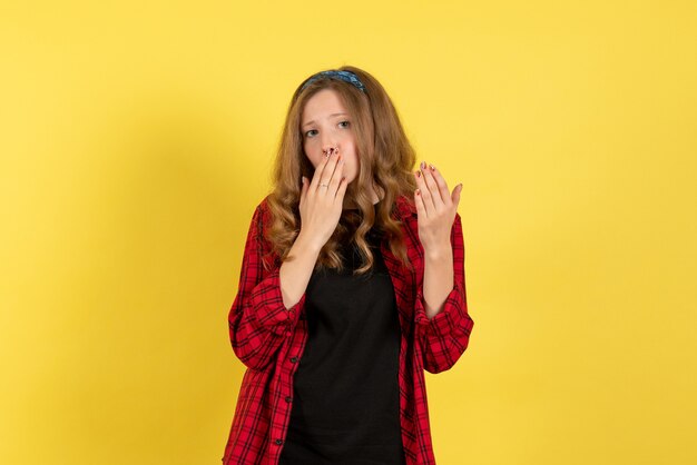 Front view young female in red checkered shirt posing on yellow background model girl woman emotion human female color