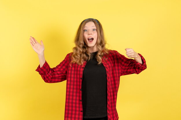 Front view young female in red checkered shirt posing on a yellow background woman human emotion model fashion girl