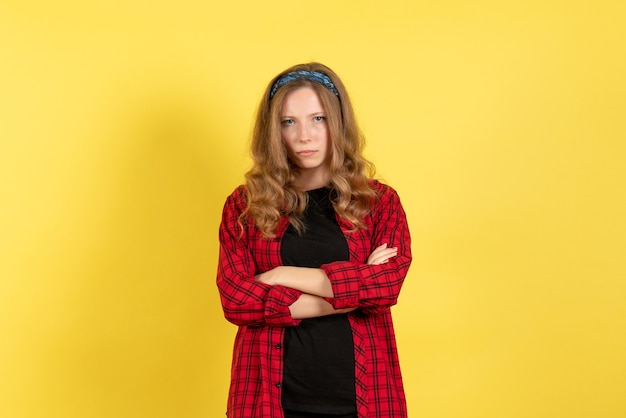 Free photo front view young female in red checkered shirt standing with mad expression on yellow background girl color woman model human