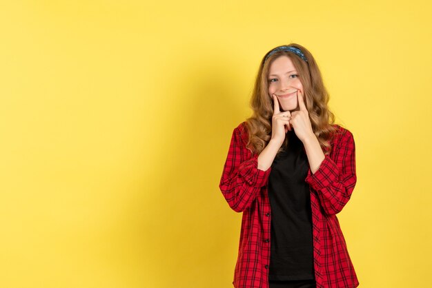 Front view young female in red checkered shirt standing on yellow background girls color model human woman