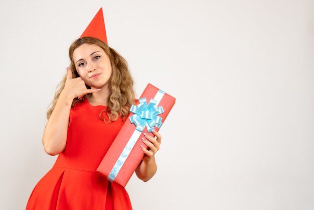 Front view young female in red dress celebrating christmas with present