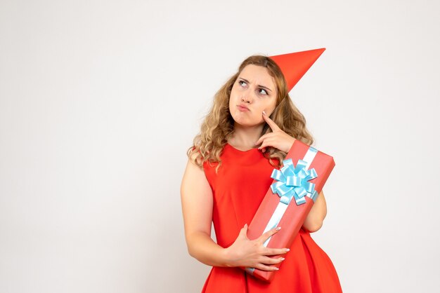 Front view young female in red dress celebrating christmas with present