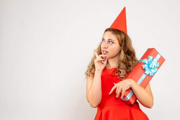 Front view young female in red dress celebrating christmas with present