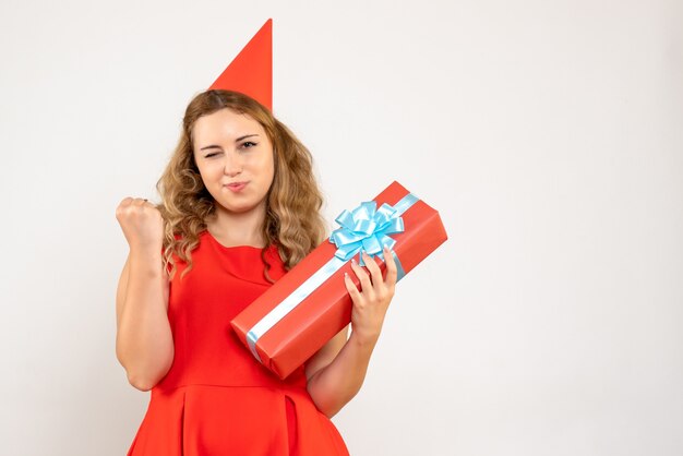 Front view young female in red dress celebrating christmas with present