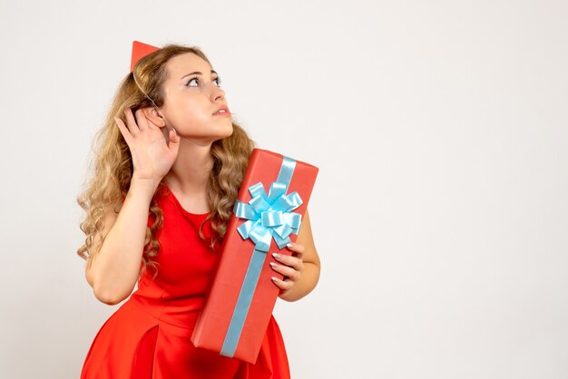Front view young female in red dress celebrating christmas with present