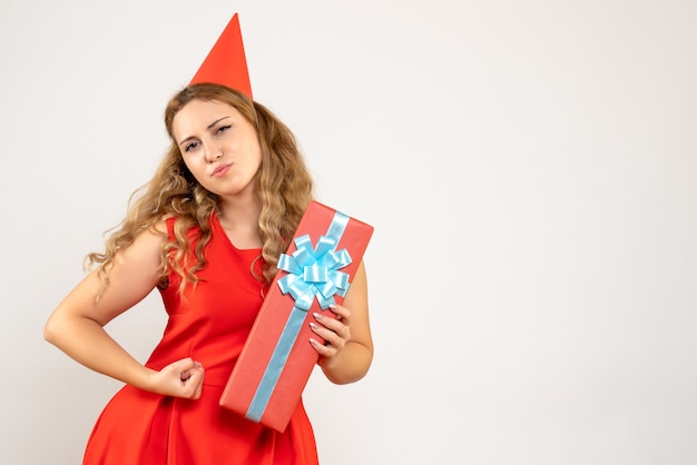 Front view young female in red dress celebrating christmas with present