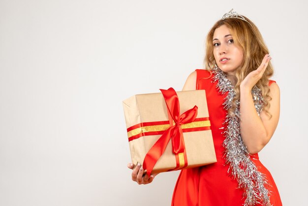 Front view young female in red dress holding christmas present