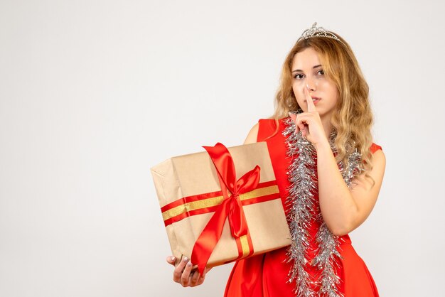 Front view young female in red dress holding christmas present