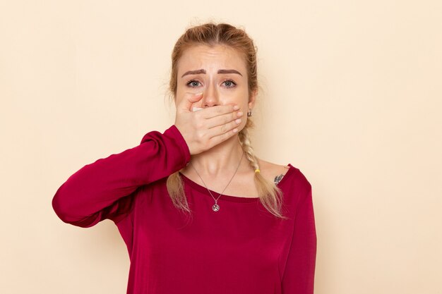 Front view young female in red shirt crying covering her mouth on the cream space female cloth  photo