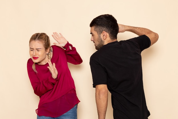 Front view young female in red shirt suffers from physical threats and violence on the cream space female cloth photo violence domestic Free Photo