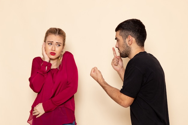 Front view young female in red shirt suffers from verbal violence on the light space female cloth  photo