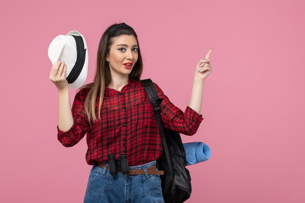 Front view young female in red shirt with hat on pink background human woman color