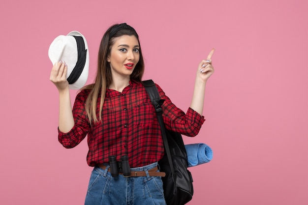 Front view young female in red shirt with hat on pink background human woman color