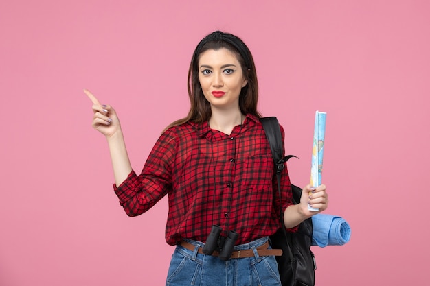 Front view young female in red shirt with map on light pink background color fashion woman