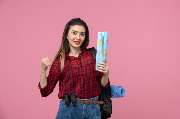 Front view young female in red shirt with map on pink background colors fashion woman