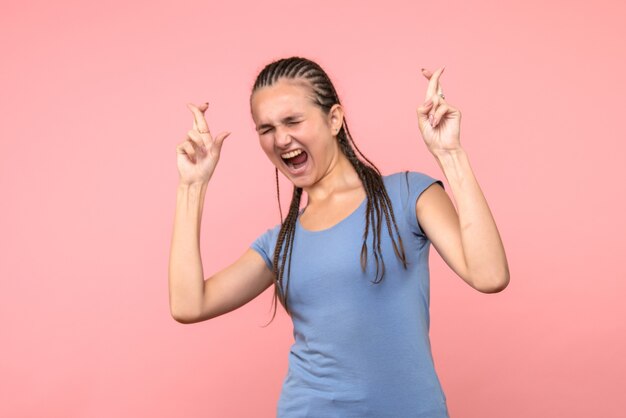 Front view of young female rejoicing on pink