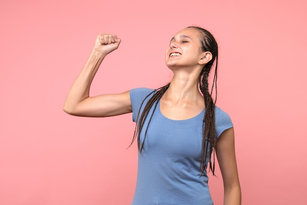 Front view of young female rejoicing on pink