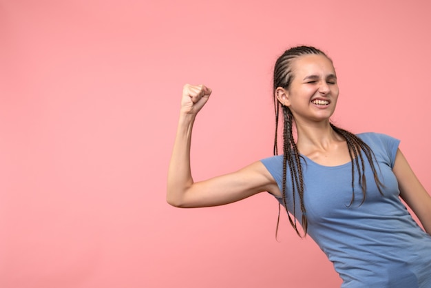 Front view of young female rejoicing on pink