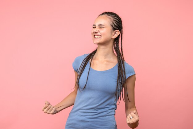 Front view of young female rejoicing on pink