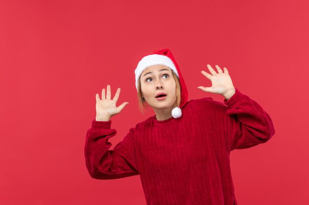 Front view young female scared of ceiling, holiday christmas red