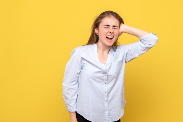 Front view of young female screaming from pain