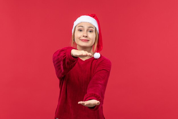 Front view young female showing size with smile, christmas holiday red