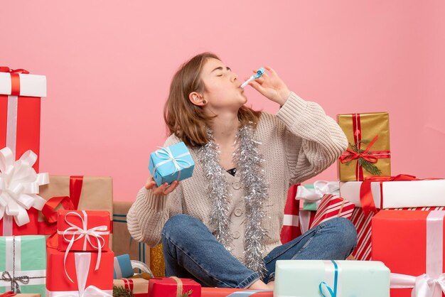 Front view young female sitting around different presents