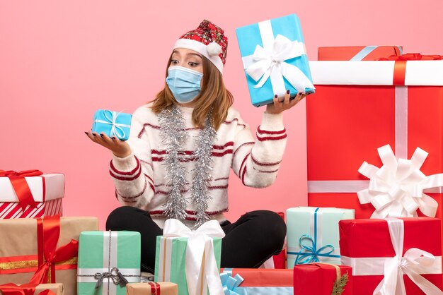 Front view young female sitting around presents