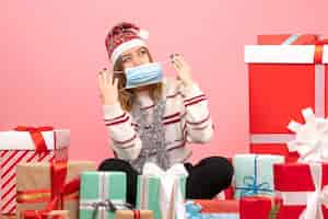 Free photo front view young female sitting around presents