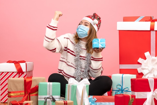 Front view young female sitting around presents