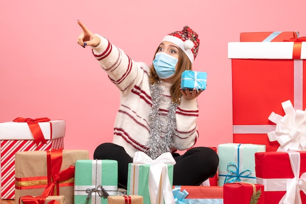 Front view young female sitting around presents