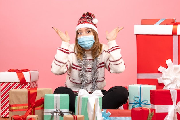 Front view young female sitting around presents