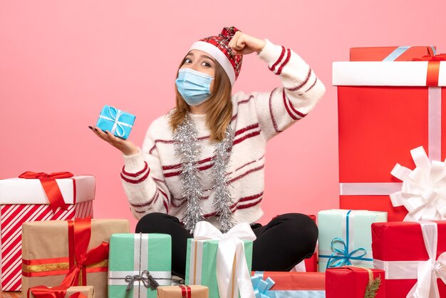 Front view young female sitting around presents