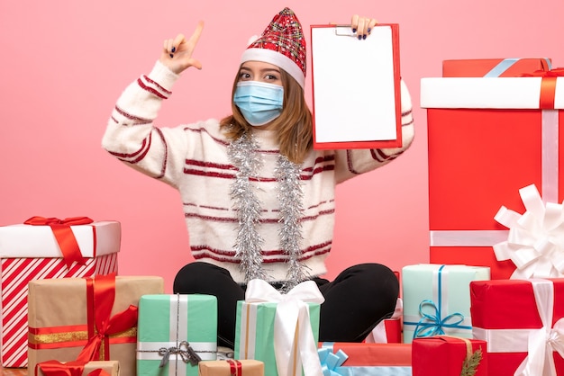 Free photo front view young female sitting around presents