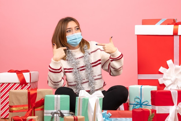 Front view young female sitting around presents