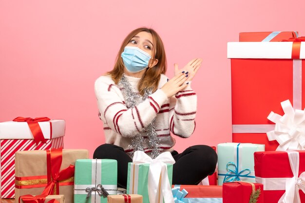 Front view young female sitting around presents