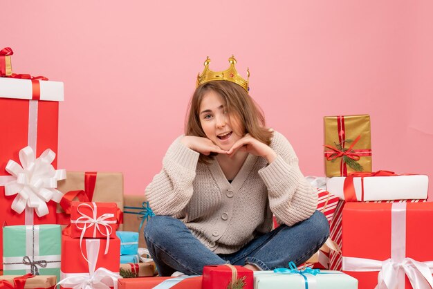 Front view young female sitting around xmas presents