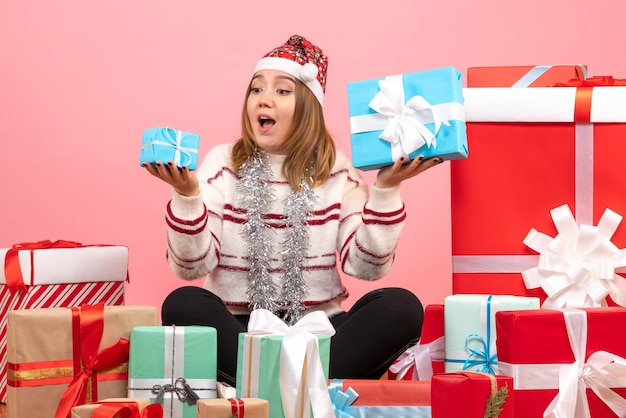 Front view young female sitting around xmas presents