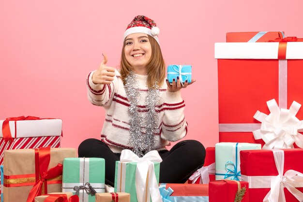 Front view young female sitting around xmas presents