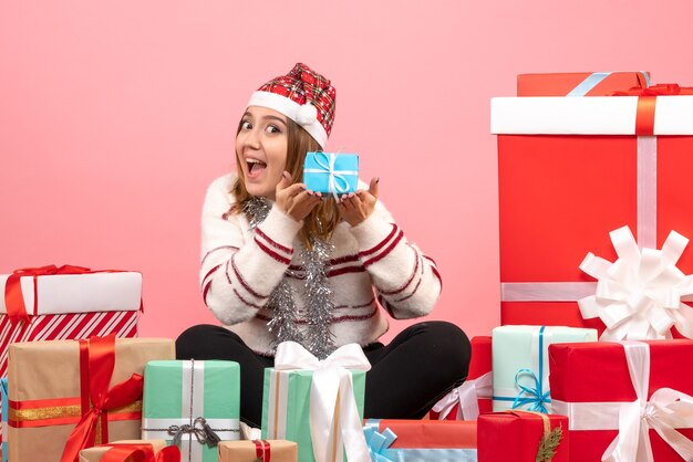 Front view young female sitting around xmas presents