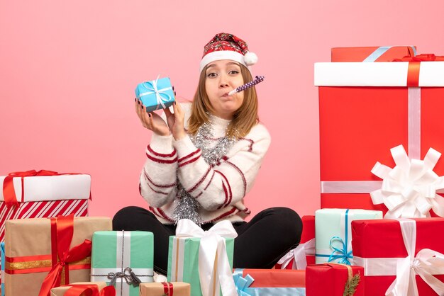 Front view young female sitting around xmas presents