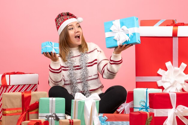 Free photo front view young female sitting around xmas presents