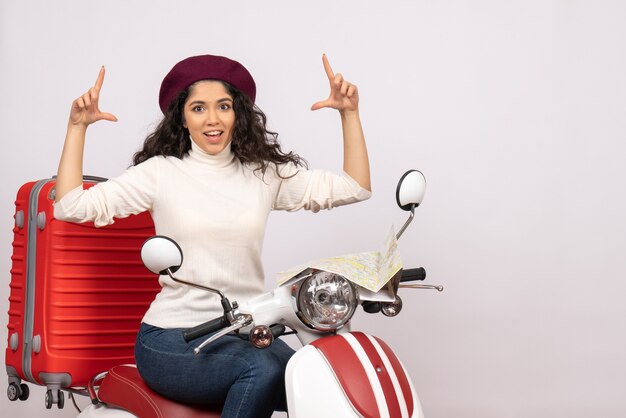 Front view young female sitting on bike on white background road vehicle city color vacation woman